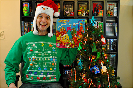 An ugly Christmas sweater featuring Pac-Man, a Christmas tree, and an absurd amount of ghosts!