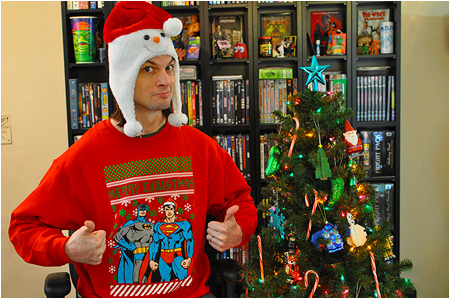 An ugly Christmas sweater featuring Superman and Batman trying to look serious!