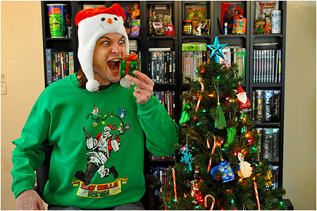 An ugly Christmas sweater featuring Megatron dressed as Santa with the severed heads of his enemies as jingle bells!
