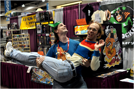 Rog holds Keith Apicary in his mighty arms at the I-Mockery booth during the 2010 San Diego Comic-Con. Destined for love... and adventure!